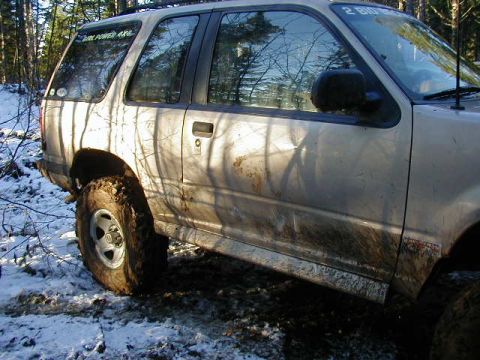 1994 Ford Explorer - Muddy 1994 Ford Explorer in a winter forest setting.