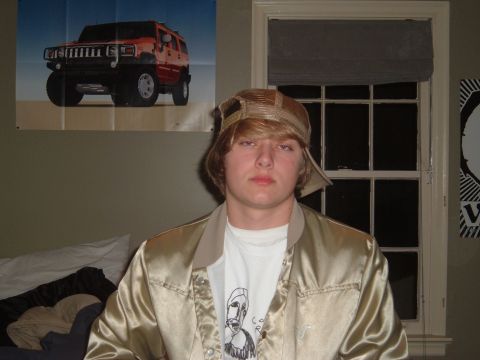 1978 Ford Bronco - Poster of a red Hummer H2 is displayed on a wall behind a person.
