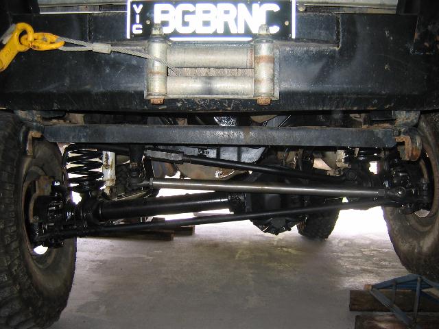 Undercarriage front view of a Bronco showing axle, coil springs and winch