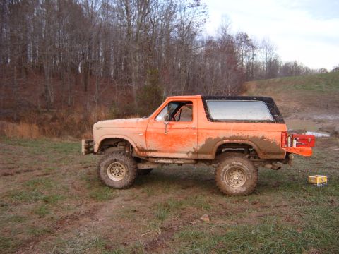 1984 Ford Bronco - This lifted Ford Bronco is covered in mud after an off-road excursion.