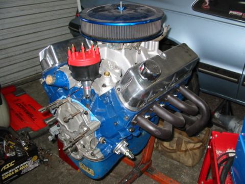 1985 Ford Crown Victoria LTD - A rebuilt V8 engine sits on a stand, ready for installation into a vehicle.