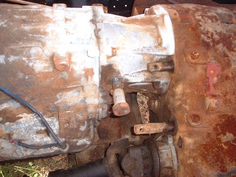 1976 Ford F-150 - Close-up view of a rusted transmission housing, likely from an older vehicle.