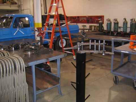 1978 Ford Bronco - Workshop scene with a blue pickup truck, ladder, and various tools and equipment.