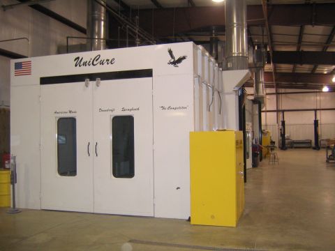 1978 Ford Bronco - A UniCure spray booth is shown inside a workshop, dual doors and a yellow equipment cabinet.