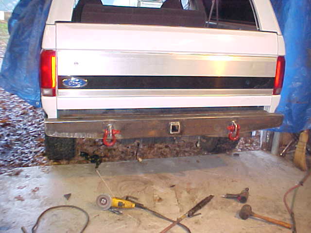 White Ford Bronco rear bumper with red tow hooks and a Ford badge