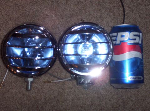 1995 Ford Bronco - Aftermarket fog lights with blue lenses and protective grilles are shown next to a can of Pepsi.