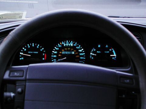 1992 Ford Taurus - The illuminated dashboard displays the vehicle's speed, engine RPM, fuel level, and temperature readings.