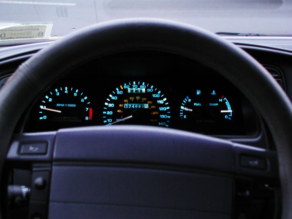 Backlit gauge cluster with 7000 rpm tach, 140 mph speedo and 174,697-mile odometer