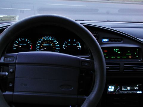 1992 Ford Taurus - The dashboard of a 1992 Ford Taurus displays illuminated instruments and climate controls.