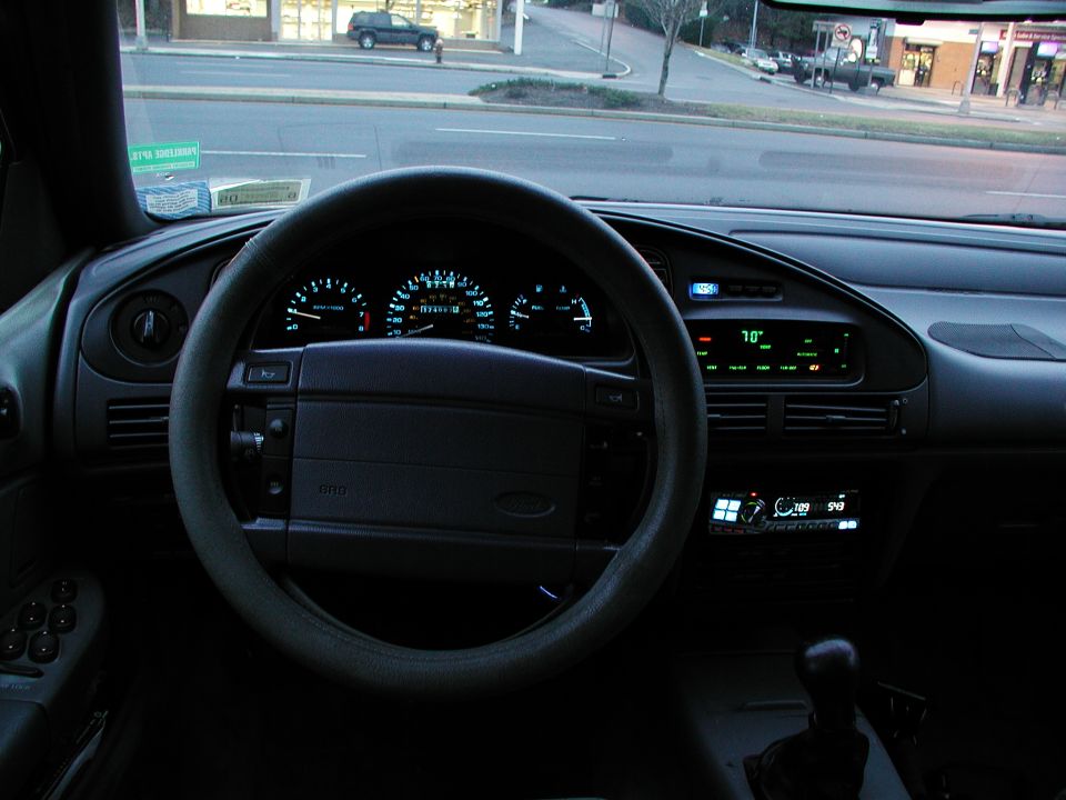 1992 Ford Taurus interior dashboard with illuminated gauges and digital climate control