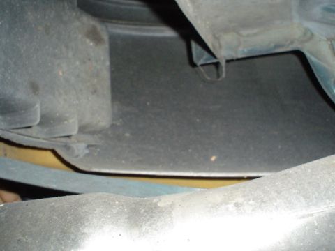1993 Ford Taurus - The underside of a vehicle's wheel well liner is visible in this close-up shot.