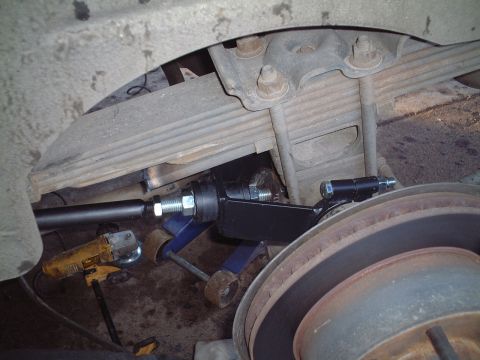 2000 Ford Excursion - Radius rod installation in progress, showing suspension components and tools.