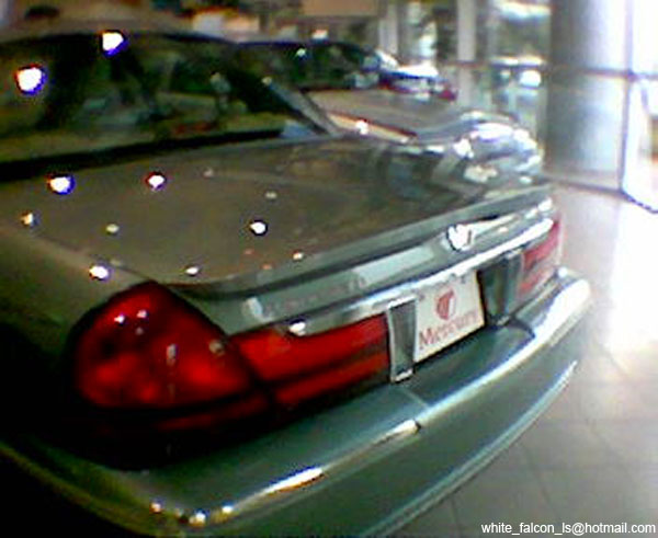 Green Mercury Grand Marquis rear, showing taillight, trunk lid, and Mercury badge