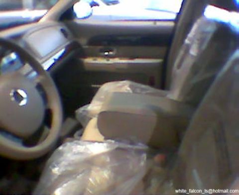 1999 Mercury Grand Marquis - Interior view of a car, showing seats covered in plastic sheeting.