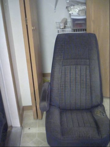 1987 Ford Bronco - A single car seat, possibly from a 1987 Ford Bronco, is shown indoors.