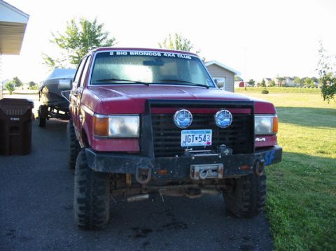 1989 Ford Bronco - This 1989 Ford Bronco is seen from the front, towing a boat and equipped with off-road lights and a winch.