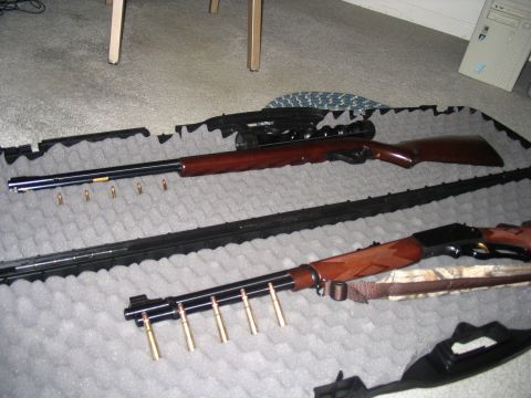 1996 Ford Taurus - Two rifles and ammunition are laid out on foam padding, with a SuperMotors.net logo in the lower right corner.