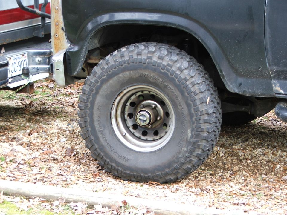 BFGoodrich Mud-Terrain tire on chrome steel wheel with locking hub on a dark Ford Bronco