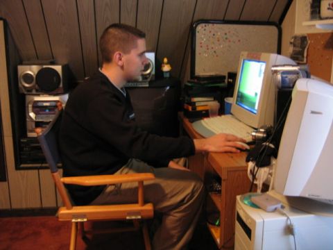 2000 Jeep Liberty - A person is seated at a desk, actively using a computer setup with multiple monitors and peripherals.