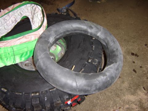 1992 Ford Bronco - Close-up of a tire inner tube and a large tire, with a strap in the background.