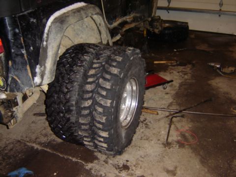 1992 Ford Bronco - A vehicle is shown in a garage with dual tires on the rear wheel, possibly undergoing maintenance.