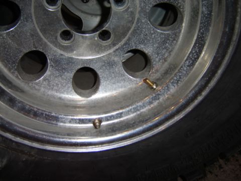 1992 Ford Bronco - Close-up of a chrome wheel, two valve stems and the edge of a tire. Text from Supermotors.net is visible in the lower right corner.