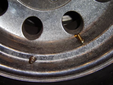 1992 Ford Bronco - This image shows a close-up of a chrome wheel, highlighting its valve stems and signs of wear.
