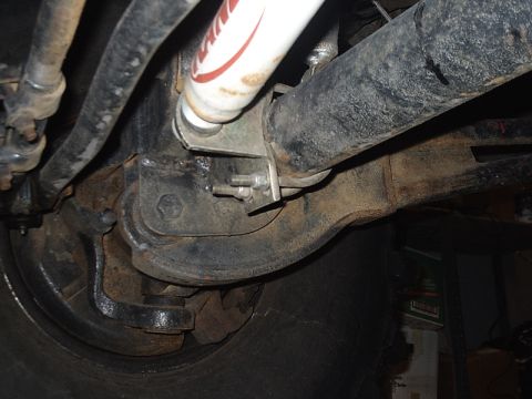 1996 Ford Bronco - Underside view of a vehicle's suspension system, highlighting the shock absorber and axle components.