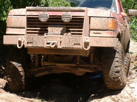 1989 Ford Bronco - This mud-covered 1989 Ford Bronco shows off its front end, complete with a winch and auxiliary lights.