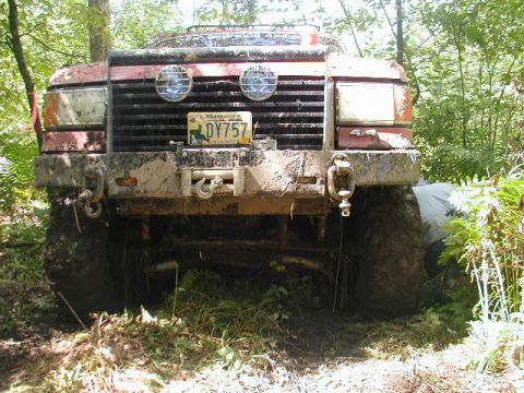 1989 Ford Bronco - This heavily muddied vehicle is shown from the front, with its license plate clearly visible.