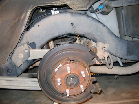 2002 Ford Crown Victoria - Rear rotor off. Notice caliper hanger made from bent wire coat hanger.