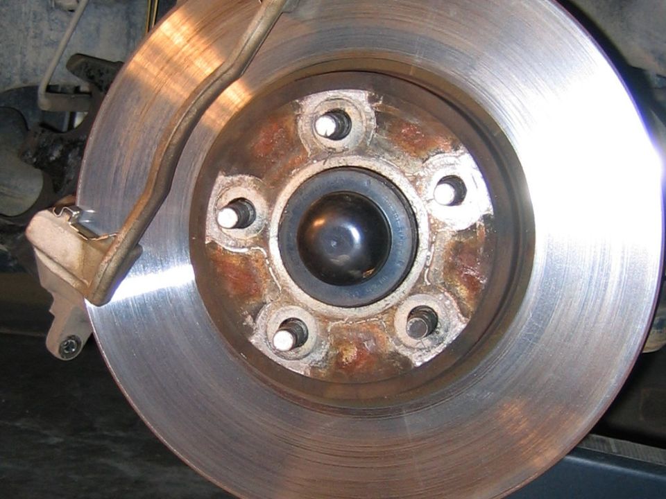 Notice no retaining rivets on OEM front rotor.