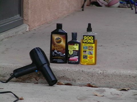 1995 Ford Contour - Car cleaning products and a hairdryer are placed on outdoor steps, suggesting preparation for detailing.