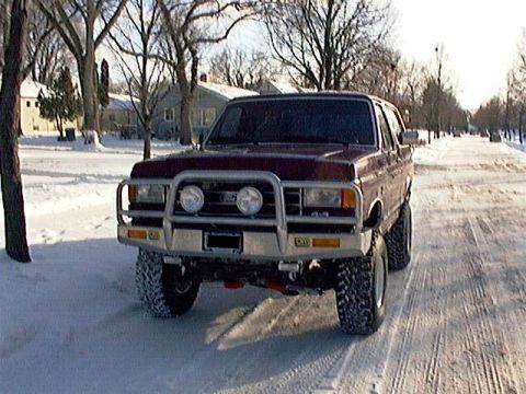 1991 Ford Bronco - This modified Ford Bronco is equipped with large off-road tires and a protective brush guard.