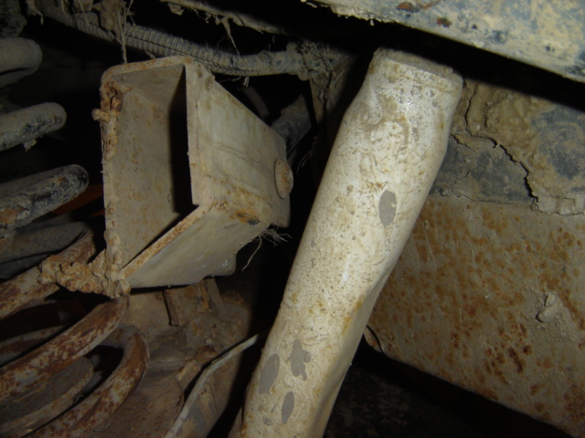close-up of rusty metal parts, possibly suspension or frame of an older vehicle