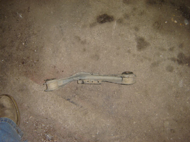 Control arm with rubber bushings on concrete floor