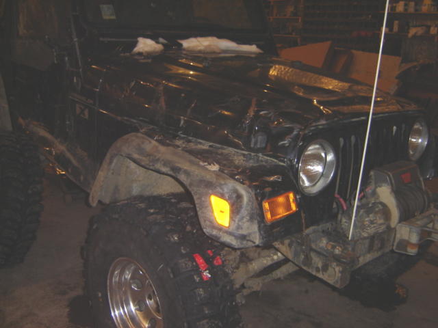 Black Jeep Wrangler with aftermarket winch and large tires