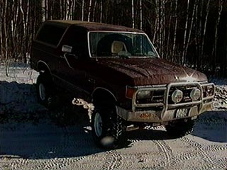 1991 Ford Bronco - This 1991 Ford Bronco is parked on a snowy road with trees in the background.