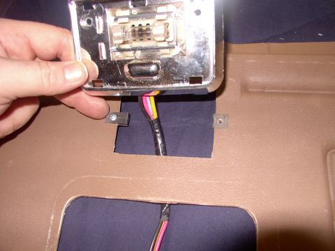 1986 Ford Bronco - Trial fitting the Fifth Avenue dome light, with the larger screw clip (end of bad finger) in place.