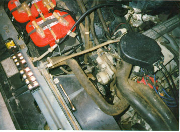 1991 Ford Bronco - Close-up view of an engine bay containing multiple batteries and engine components.