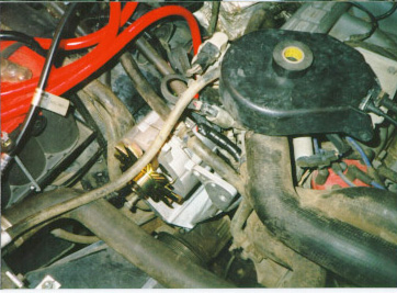1991 Ford Bronco - A complex network of hoses and electrical wiring is visible in this engine bay.