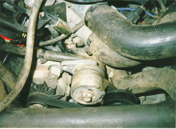 1991 Ford Bronco - Close-up view of an engine compartment, focusing on the alternator and associated components.