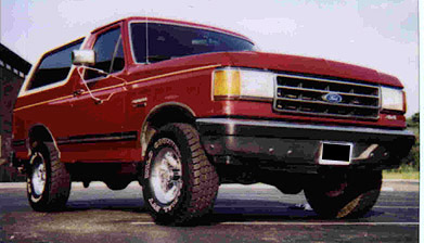 1991 Ford Bronco - Red 1991 Ford Bronco with aftermarket wheels and tires.