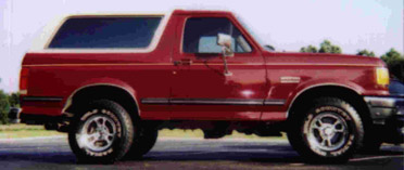 1991 Ford Bronco - This red Ford Bronco with a white top is a 1992 model, not a 1991 as claimed.