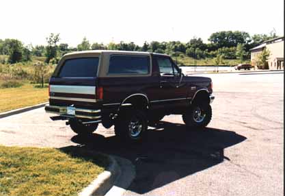 1991 Ford Bronco - This 1991 Ford Bronco is shown from the rear quarter angle, parked on asphalt.