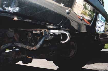 1991 Ford Bronco - The rear of a black SUV is shown, focusing on the bumper and trailer hitch assembly.