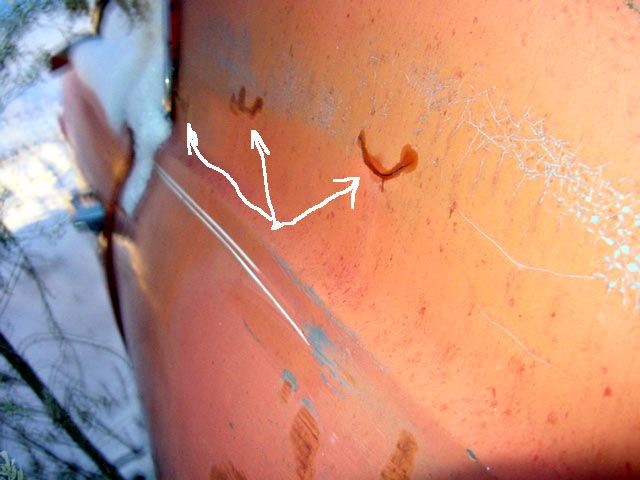 the arrows point to cracks in the rear roof pillar. The worst one is just as it goes around to the rear window. The car is breaking up.