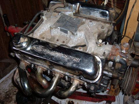 1985 Ford F-150 - A Ford V8 engine is shown with chrome valve covers and exhaust headers.