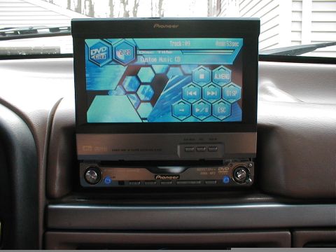 1995 Ford Bronco - Interior view of a Pioneer car stereo system with a flip-out screen showing track information for a custom music CD.