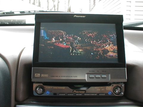 1995 Ford Bronco - A Pioneer screen displays a concert scene above a Pioneer DVD player in a vehicle's dashboard.